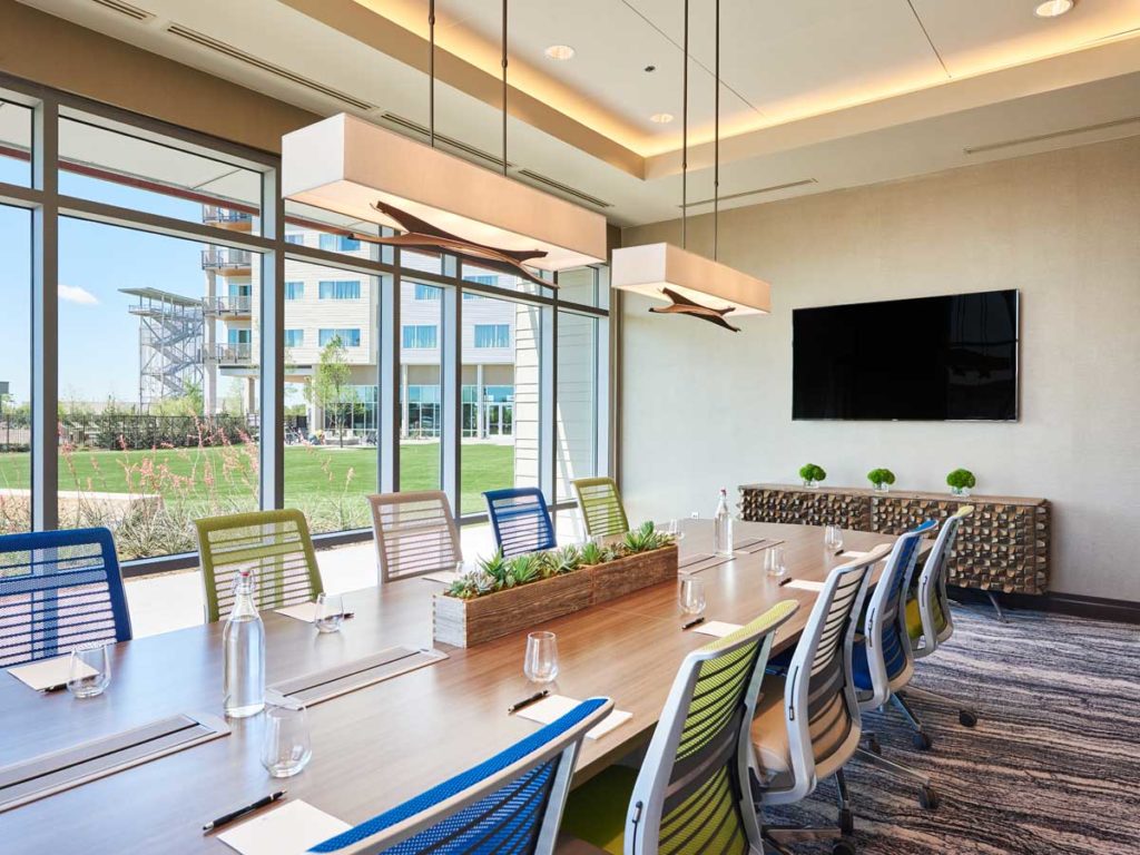 Meeting table in room with large windows.